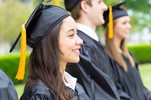 istock Diverse group of students in graduation caps and gowns 180698136