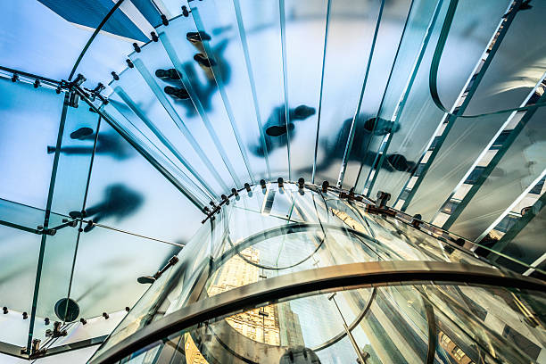 People walking on transparent glass staircase "People walking on transparent glass spiral staircase in futuristic building, unrecognizable people." spiral photos stock pictures, royalty-free photos & images
