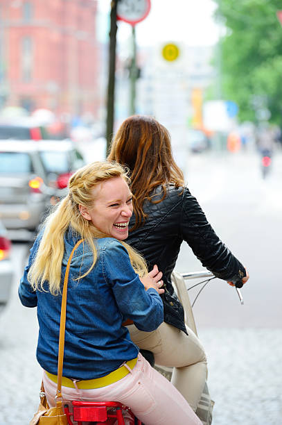 istock Young women on moving bike 180698215