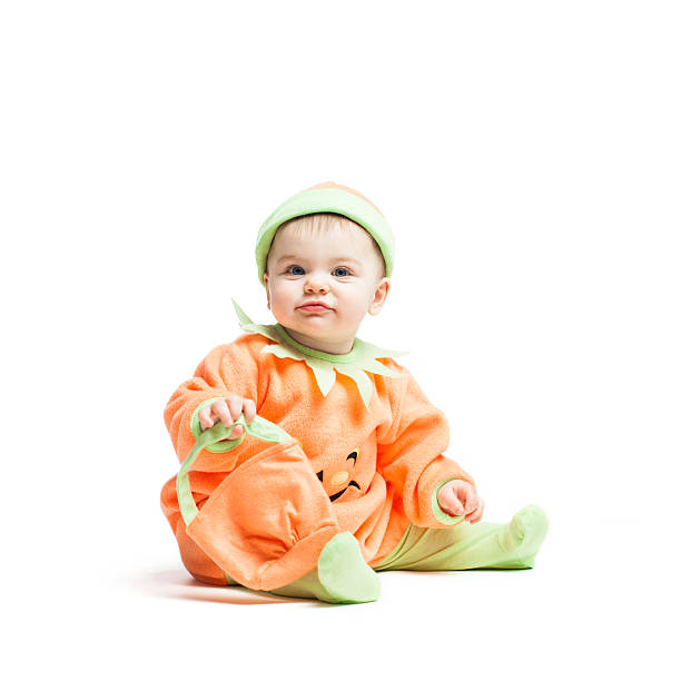 Cute baby wearing a pumpkin costume.
