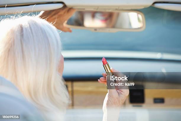 Senior Mujer Aplicar Lápiz Labial En Convertible Foto de stock y más banco de imágenes de Pintalabios - Pintalabios, Tercera edad, Adulto maduro