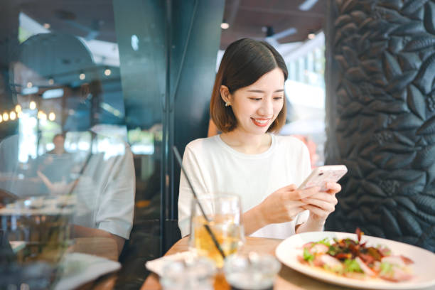 istock Business freelance asian woman using smartphone and laptop computer rest at cafe restaurant lifestyle 1806993614