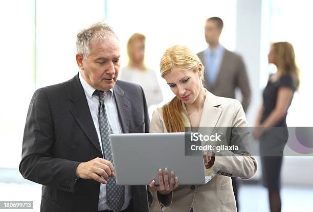 Senior Businessman With Assistant Stock Photo - Download Image Now - 30-39 Years, 50-59 Years, Active Seniors