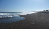 Black sand beach panorama on sunny day