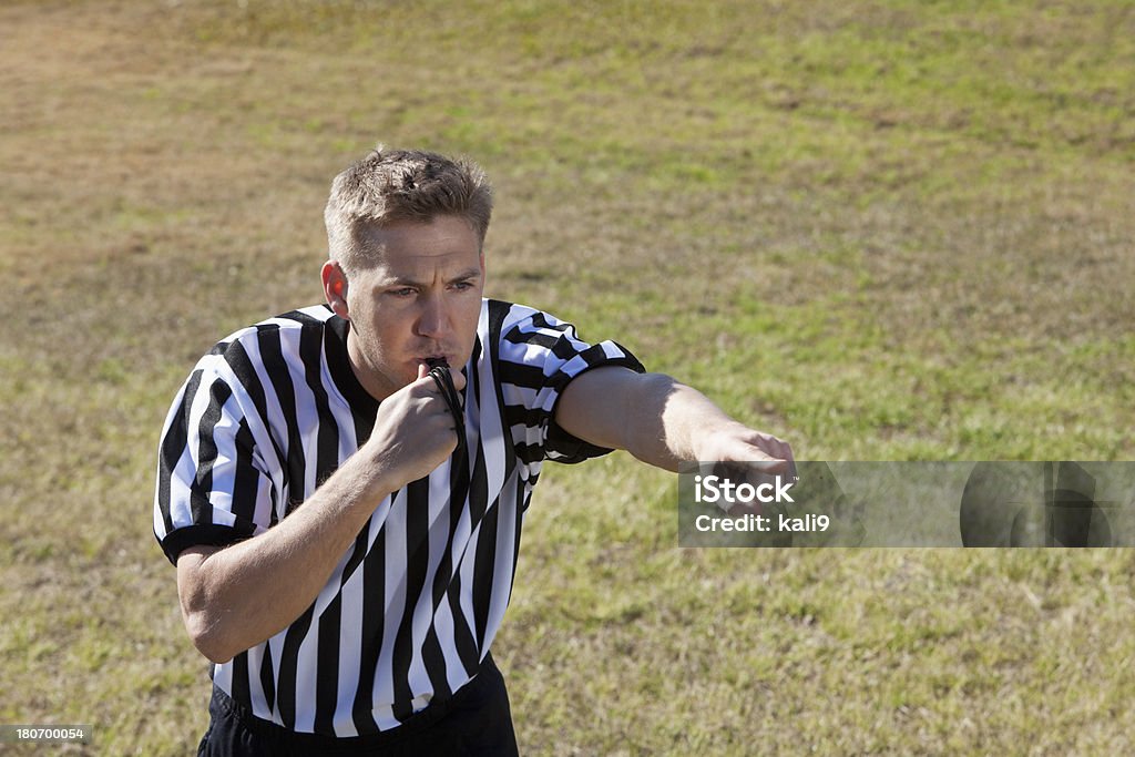 Soccer referee Soccer referee (20s) blowing whistle. 20-29 Years Stock Photo