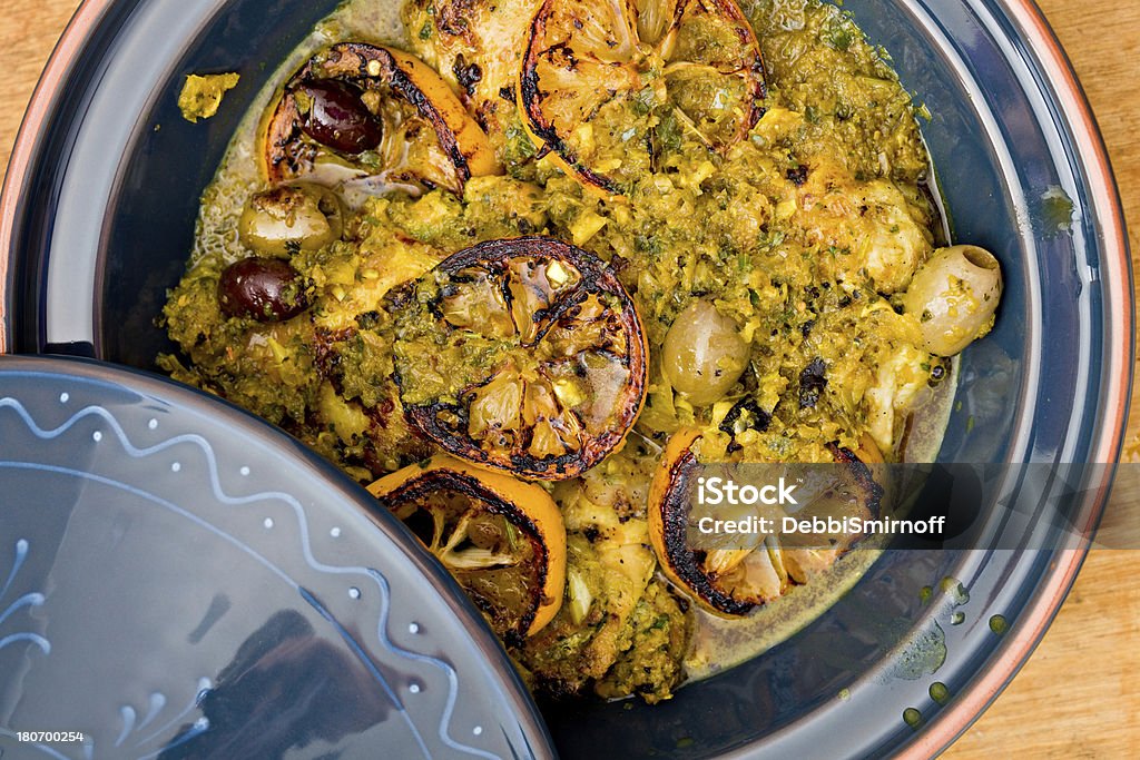 Moroccan Chicken Tagine An overhead close up shot of a blue tagine full of Moroccan chicken with preserved lemons and olives. Tajine Stock Photo