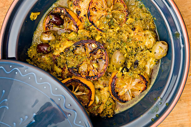 Moroccan Chicken Tagine An overhead close up shot of a blue tagine full of Moroccan chicken with preserved lemons and olives. tajine stock pictures, royalty-free photos & images