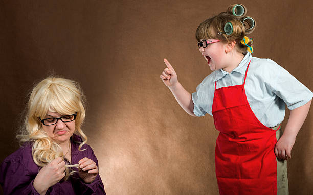 little mother yelling at daughter stock photo