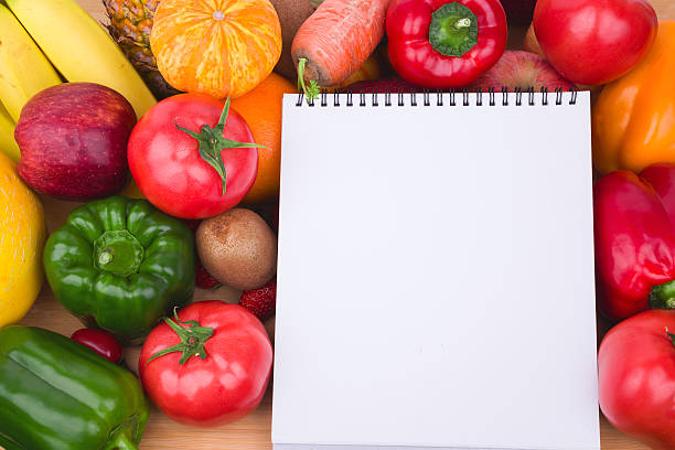 istock Vegetables fruits variety and blank note book 180701182