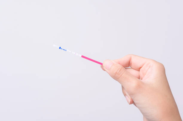 istock Close up woman using Ovalation (LH) test  or (HCG Pregnancy test) on white background 1807012614