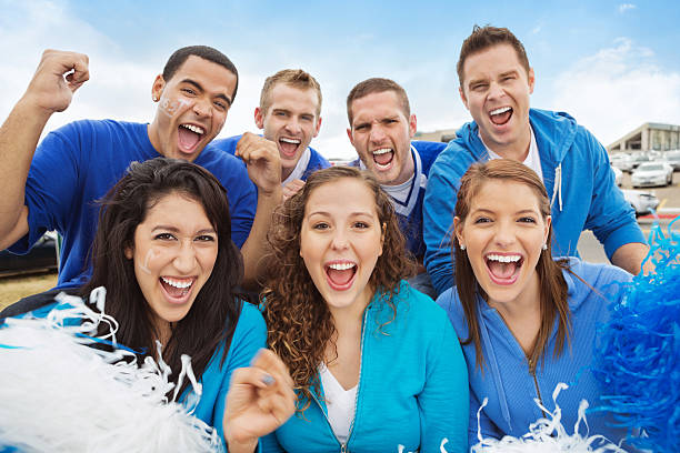 Excited group of sports fans celebrating at tailgate party Excited group of sports fans celebrating at tailgate party tailgate party photos stock pictures, royalty-free photos & images