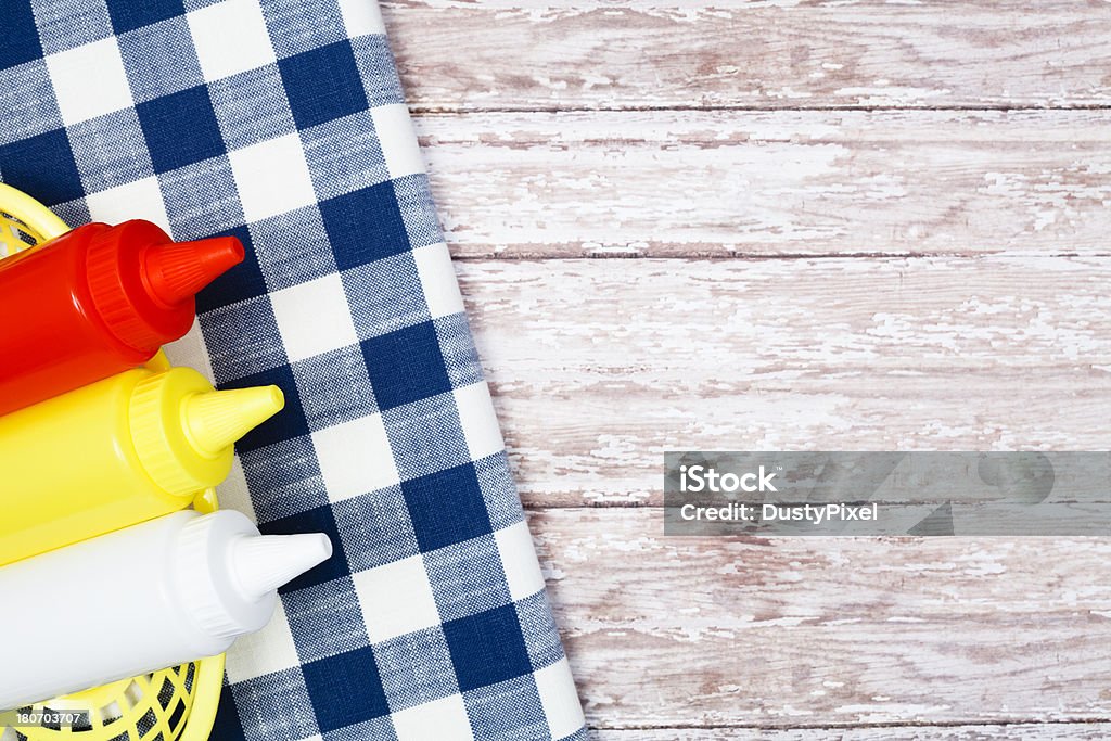Picnic Condiments Picnic table with bottles of ketchup, mustard and mayo American Culture Stock Photo