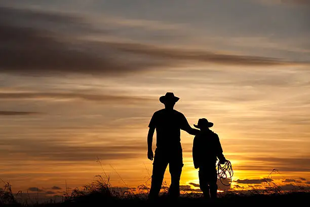 Photo of Father and Son Cowboy Silhouette