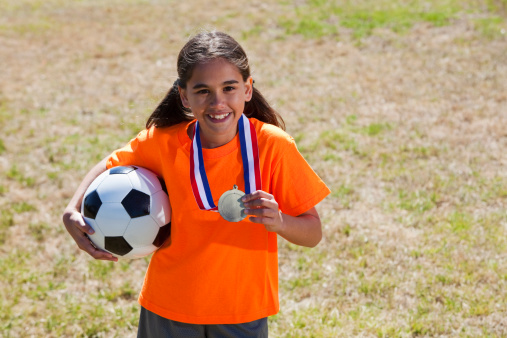Mixed race girl (Caucasian / Latin, 11 years) wins soccer award.