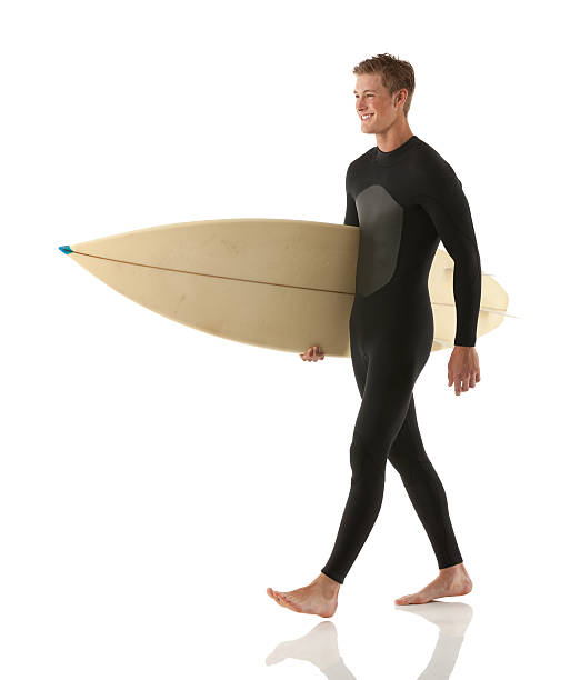 istock Smiling male surfer carrying a surfboard 180704002