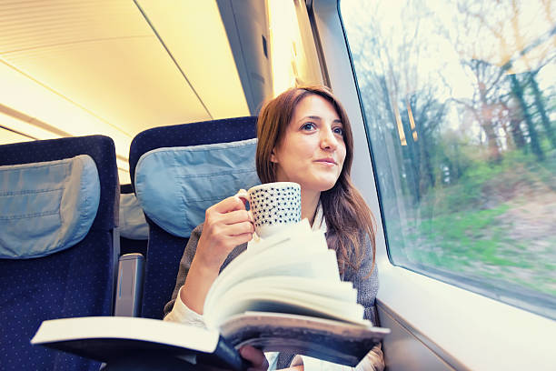 istock A young woman drinking coffee inside a running train 180704103
