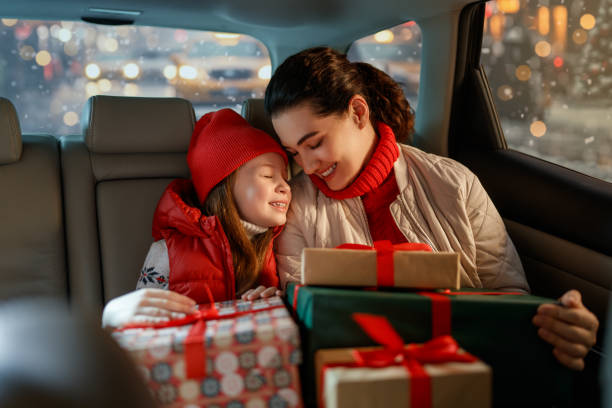 Woman and her child  holding presents stock photo