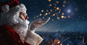 Santa Claus looking at the night city