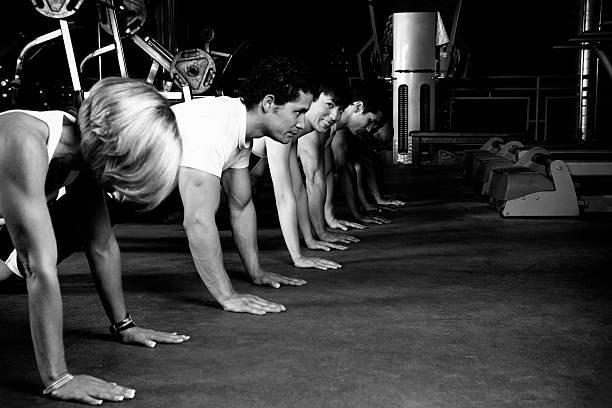 istock Row Of People Doing Push Ups At The Gym 180704973