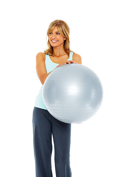 istock Attractive female exercises using fitness ball 180705224