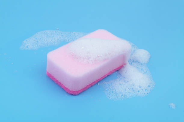 istock Pink sponge with foam on blue background. 1807057807