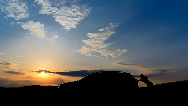 istock woman pushing car 180706306