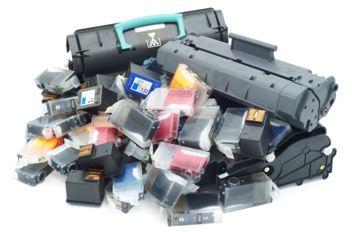 Used printer cartridges pile isolated on white