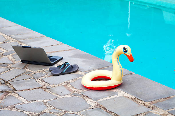 istock PC, Flip Flop, Life Preserver closed to a Swimming Pool 180707884