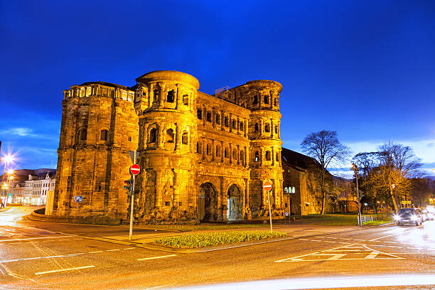 Trier's ancient Roman city gate, Porta Nigra by night "Trier's ancient Roman city gate, Porta Nigra by night. Porta Nigra is a World Heritage Site." blue yellow lights stock pictures, royalty-free photos & images