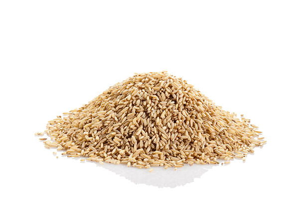 istock Whole brown rice against white background 180708614