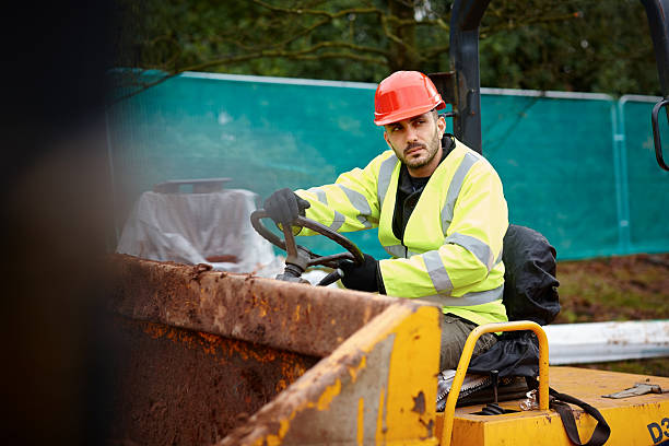 istock Young male construction worker driving an earth mover 180708643