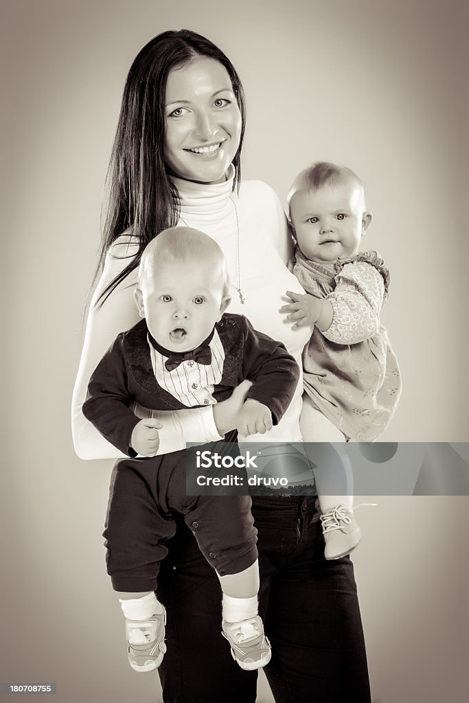 Jovem mãe segurando um irmão e uma irmã de solteiro - Foto de stock de 20-24 Anos royalty-free