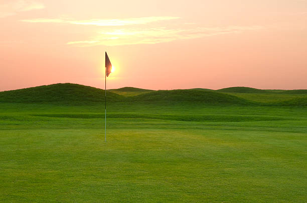 istock Golf course with green mounds at sunset 180708758