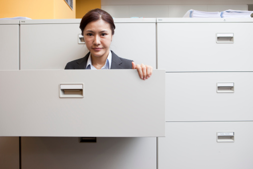 Young japanese woman in a drawer in office.