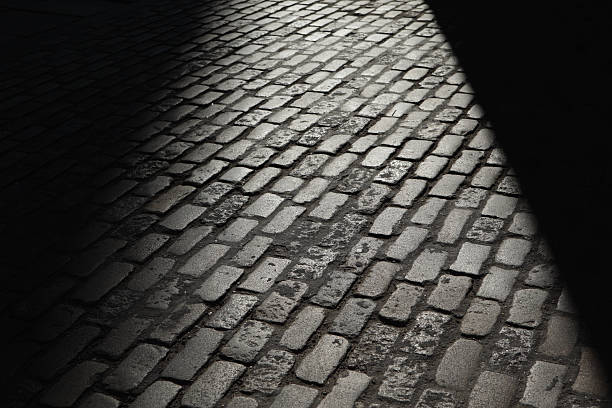 istock Gray night shadows cobblestones street 180709498