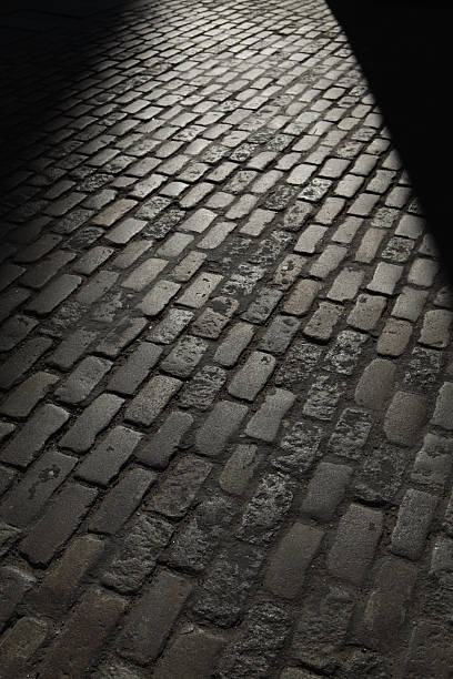 istock Gray night shadows cobblestones street 180709612