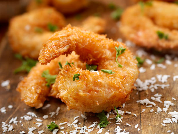 Coconut Shrimp Coconut Jumbo Shrimp with fresh Parsley and lemon - Photographed on Hasselblad H3D2-39mb Camera breaded photos stock pictures, royalty-free photos & images