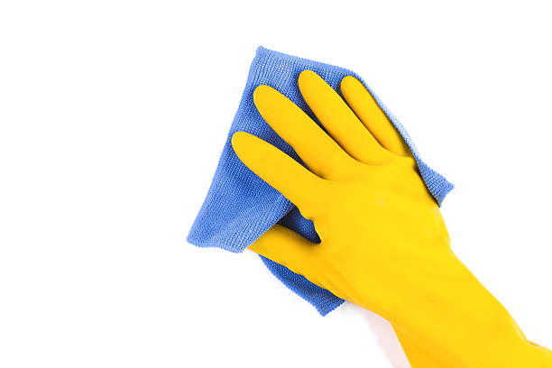 Cleaning:yellow glove and rag isolated on white background stock photo