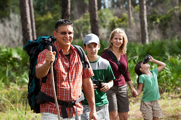 Hispanic family hiking in woods