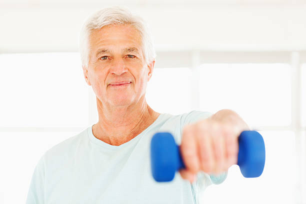 istock Senior Man Exercising With Dumbbell 180710940