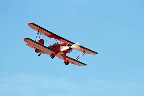 Remote control model bi-plane in flight.