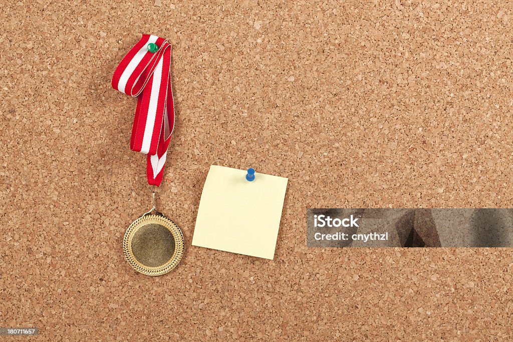 Blank Gold Medal with Post-it on Corkboard Achievement Stock Photo