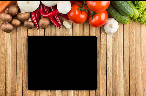 istock Digital tablet on wooden surface with vegetables 180711812