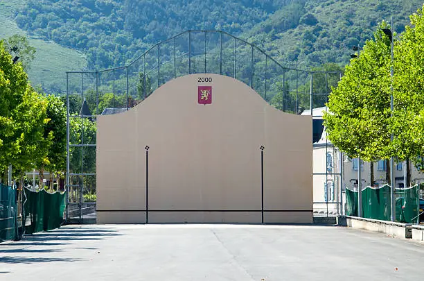 A fronton is a court used as playing area for Basque pelota. The open-air single walled fronton is photographed in Mauleon-Licharre.