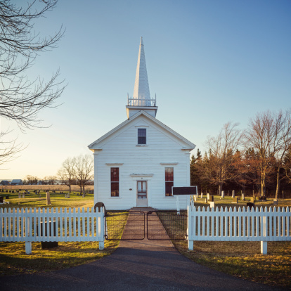 A quaint church behind a white picket fence in rural Nova Scotia.