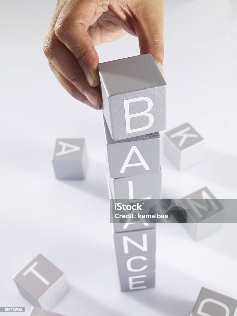 Balance Businessman forming words from alphabet blocks. Adult Stock Photo