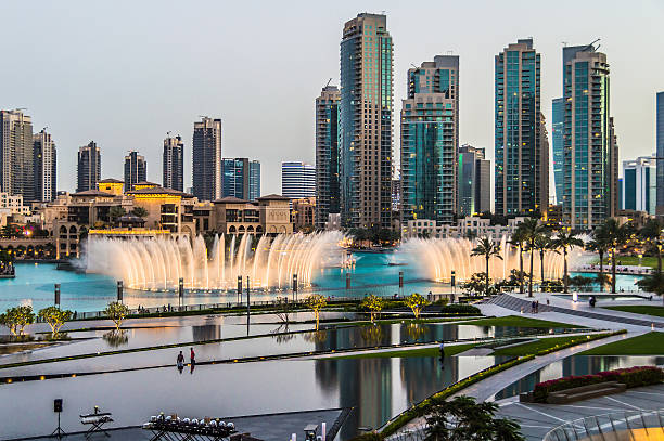 Dubai Skyline from the Burj Khalifa View from Armani Hotel at the Burj Khalifa to the water installations in the evening. Some office building skyscrapers in the background. jumeirah stock pictures, royalty-free photos & images