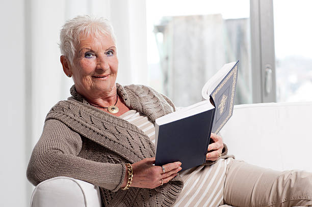istock Senior woman reading bible 180713804