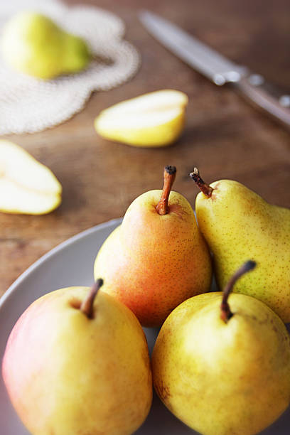 istock Pears fruits on plate on a rustic wooden table 180714126