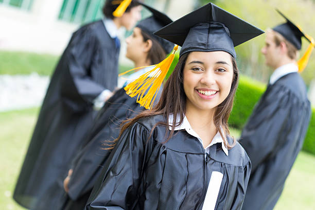 istock Cute hispanic girl graduating with classmates 180714357